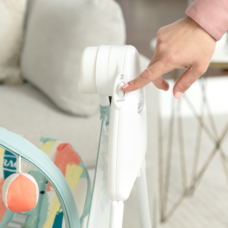 Woman controlling the speeds of Graco Baby Delight swing