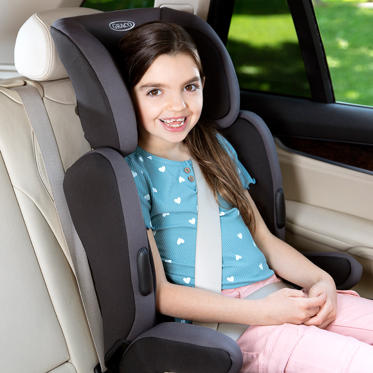 Young girl sitting forward facing in Graco Endure car seat with adjustable headrest