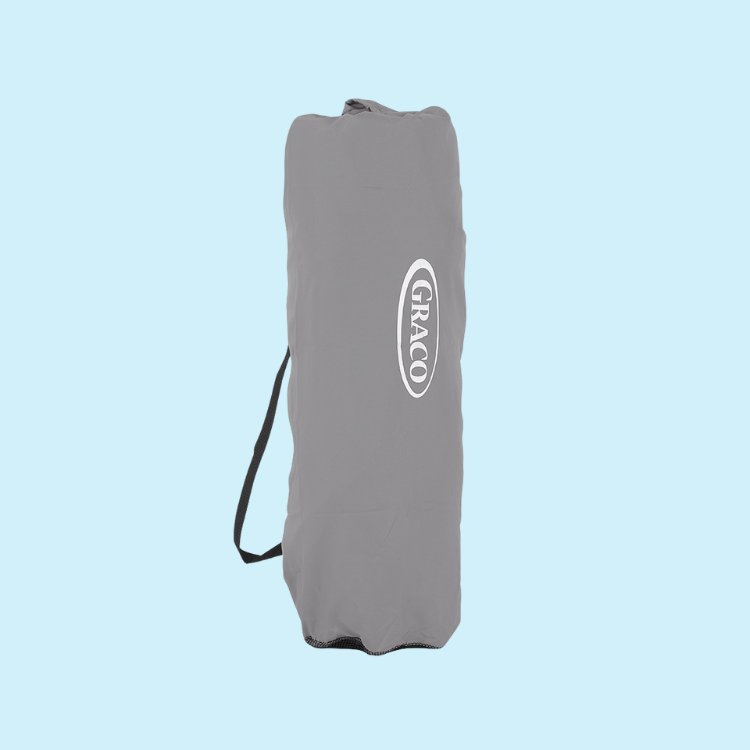 Graco EverGo Lite playpen folded in carry bag on light blue background.