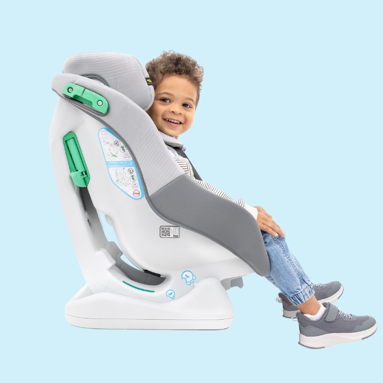 Woman's hand pulling up the no-rethread harness of the Graco Extend LX R129 car seat