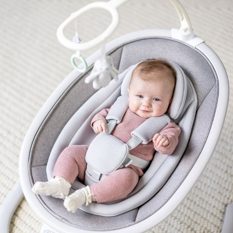 Mum operating the control panel of Sway 'n Grow 3-in-1 silent swing 