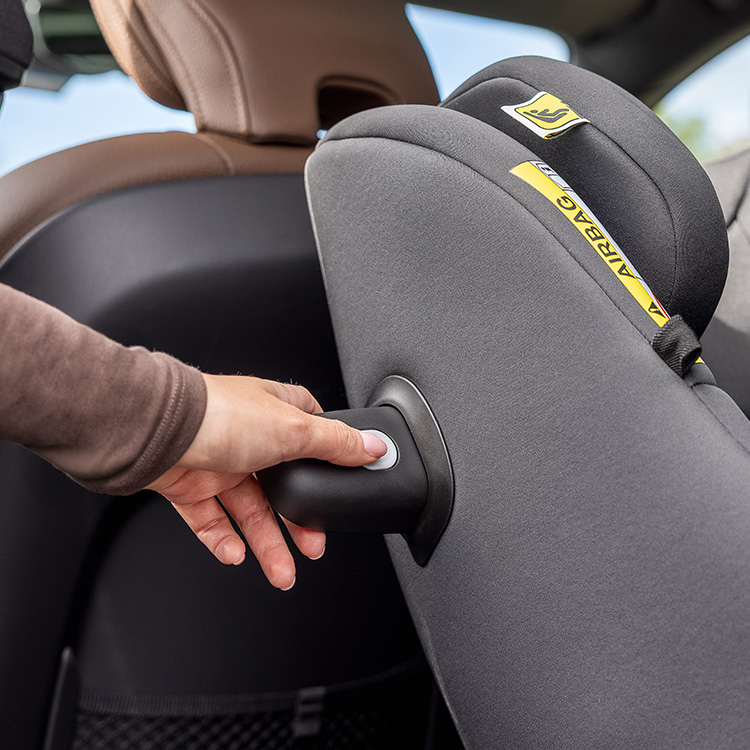 Profile view of baby sitting in Graco Turn2Me DLX i-Size R129 in rearward facing mode with the anti-rebound bar highlighted.