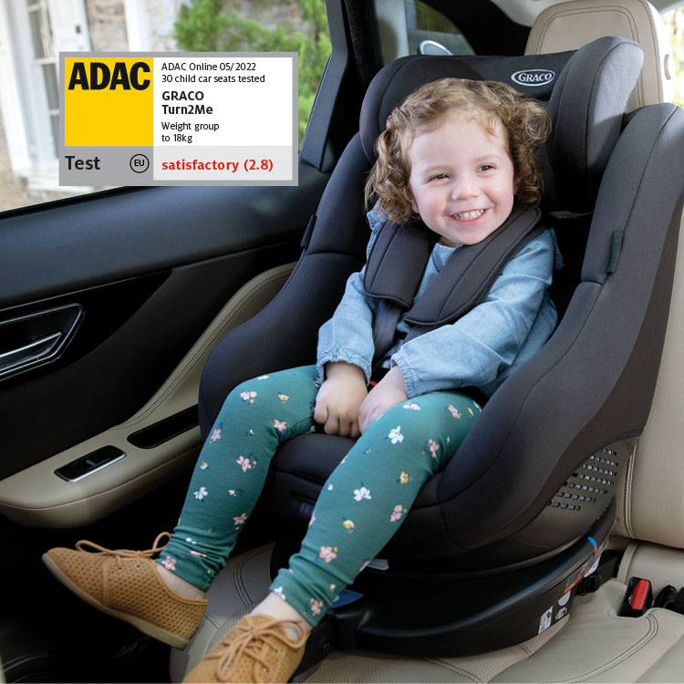 Girl buckled in Graco Turn2Me R44 car seat with ADAC logo