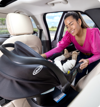Young girl laughing while buckled into Energi i-Size R129  2-in-1 harness booster car seat.