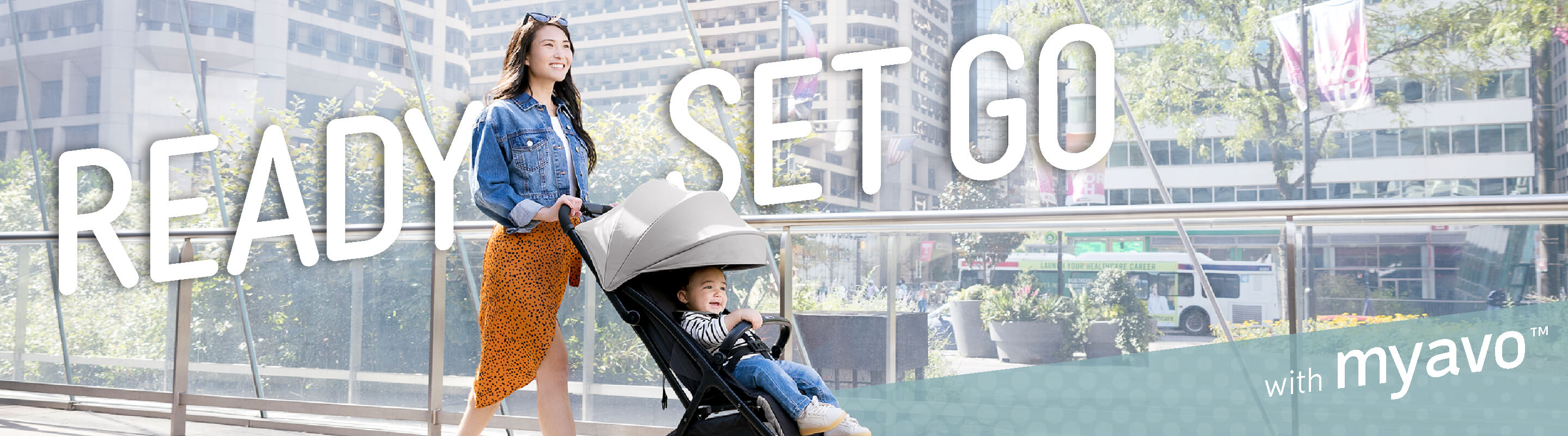 Mum and baby walking through the city in Graco Myavo with Ready, Set, Go text. 