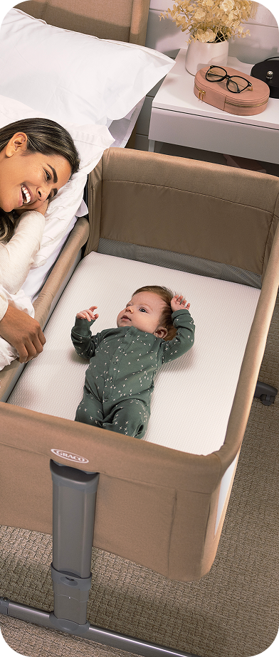 Little girl smiling while buckled into SnackEase quick-folding highchair.
