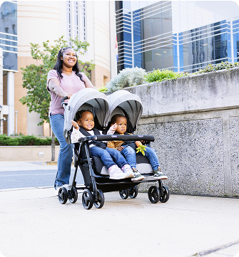 Mum and dad smiling and walking while pushing toddler in Myavo quick-folding lightweight travel stroller.