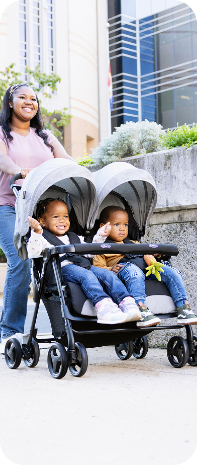 Mum and dad smiling and walking while pushing toddler in Myavo quick-folding lightweight travel stroller.