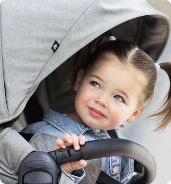 Mum and dad smiling and walking while pushing toddler in Myavo quick-folding lightweight travel stroller.